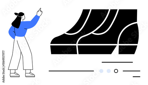 Woman in blue sweater and white pants pointing at large black shoe models. Ideal for fashion design, footwear industry, product presentation, creative thinking, innovation, marketing, modern art