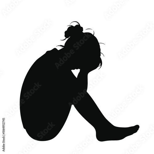 a black silhouette of a person sitting on the ground with their head in their hands.
