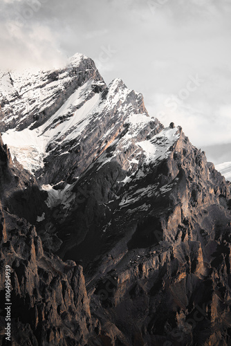 landscape of mountains with snow on the top, surrounded by forests with beautiful pine trees on autumn days during a clear sky