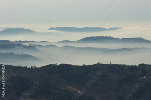 a mysterious landscape of mountains shrouded in fog and towering over the Mummelsee in Germany High quality photo photo