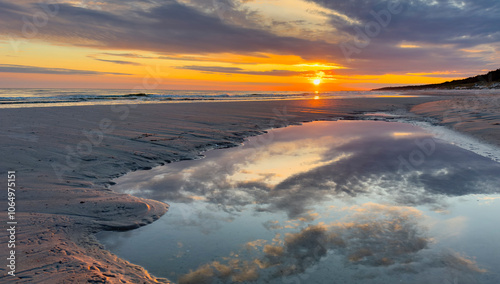 Fototapeta Naklejka Na Ścianę i Meble -  Cloud landscape with sun on a natural beach on the Baltic Sea