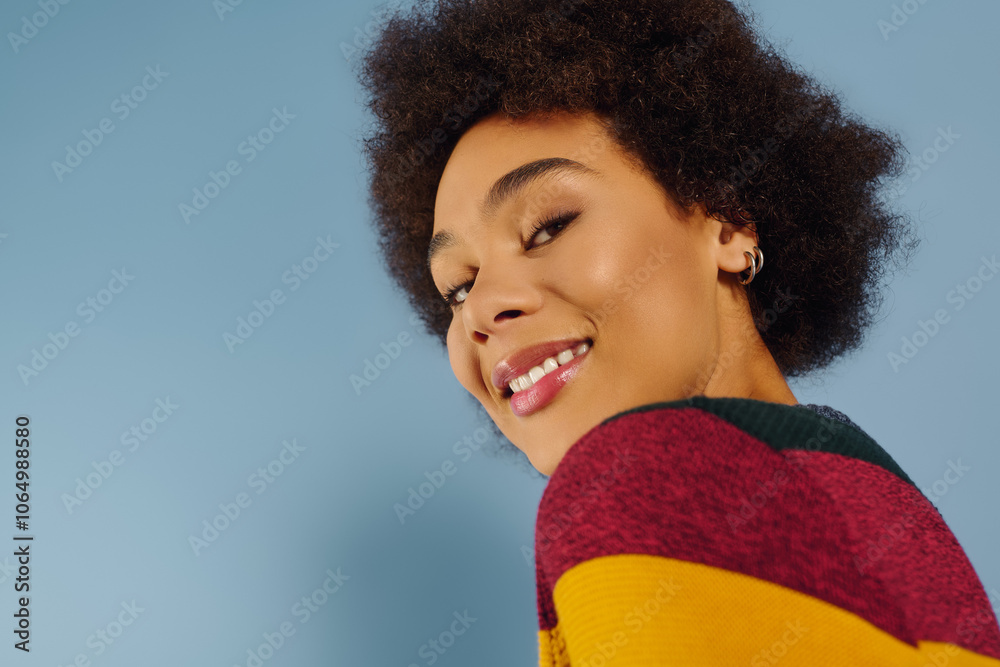 A joyful young woman shines with vibrant curls in a playful atmosphere. A joyful young woman shines with vibrant curls in a playful atmosphere.