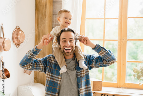 фотографія Happy young caucasian father dad playing piggyback with little small kid child toddler infant, spending time together