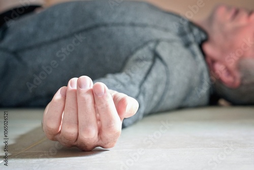 Man lying on the floor at home, epilepsy, unconsciousness, faint, stroke, accident  or other health problem