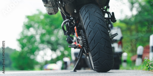 Motorcycle cruising down the road under the golden sunset, basking in the warm glow. A perfect moment to hit the open road with endless possibilities ahead. Space for your personalized message. photo