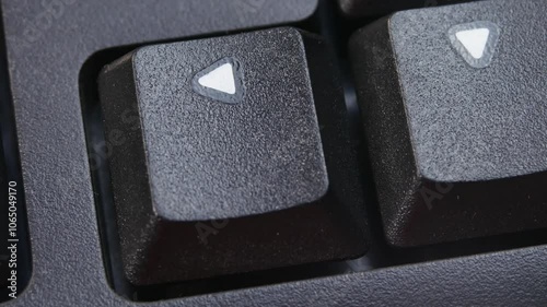 Left Arrow Key on Desktop Keyboard Pressed by Finger Hand Multiple Times - Close Up Macro Shot