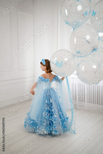 little girl in blue dress with giant helium balloons 