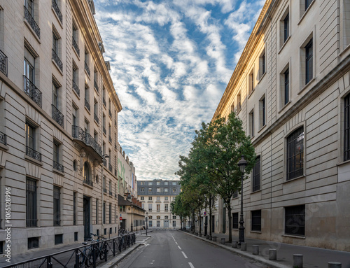 Fototapeta Naklejka Na Ścianę i Meble -  Paris, France - 10 28 2024: View of a typical street with buildings and a zebra sky  .