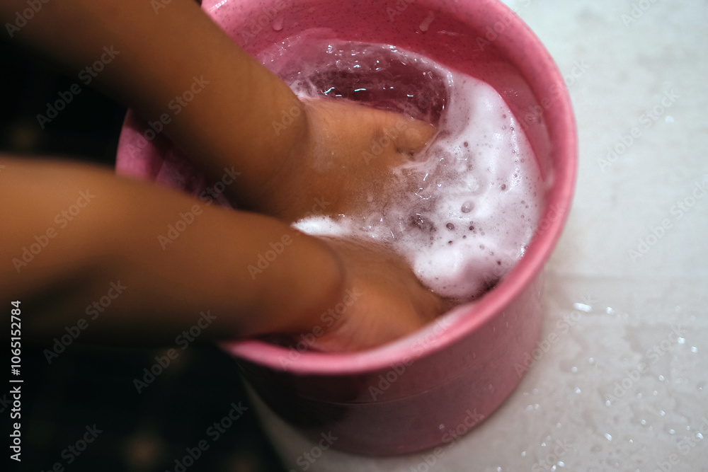 Fototapeta premium close up of child's hand with soap foam