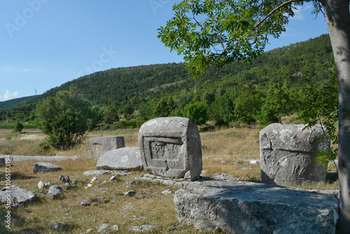 Necropolis Velika and Mala Crljivica (Big and Small Crljivica) near the village of Cista Velika in Croatia with tombstones decorated with intricate carvings photo