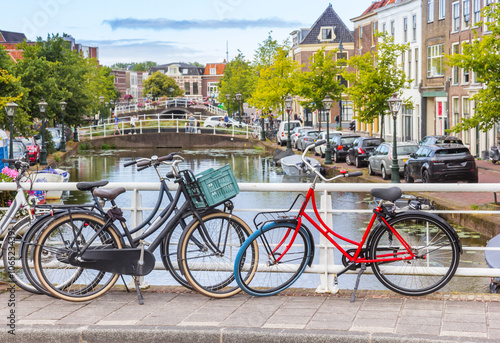 Bicycles parked on the bridge over the Nieuwe Mare canal in Leiden, Netherlands photo