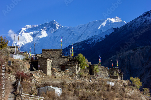 Photography View of the alpine village of Manang below the foothills of the Himalayan peaks