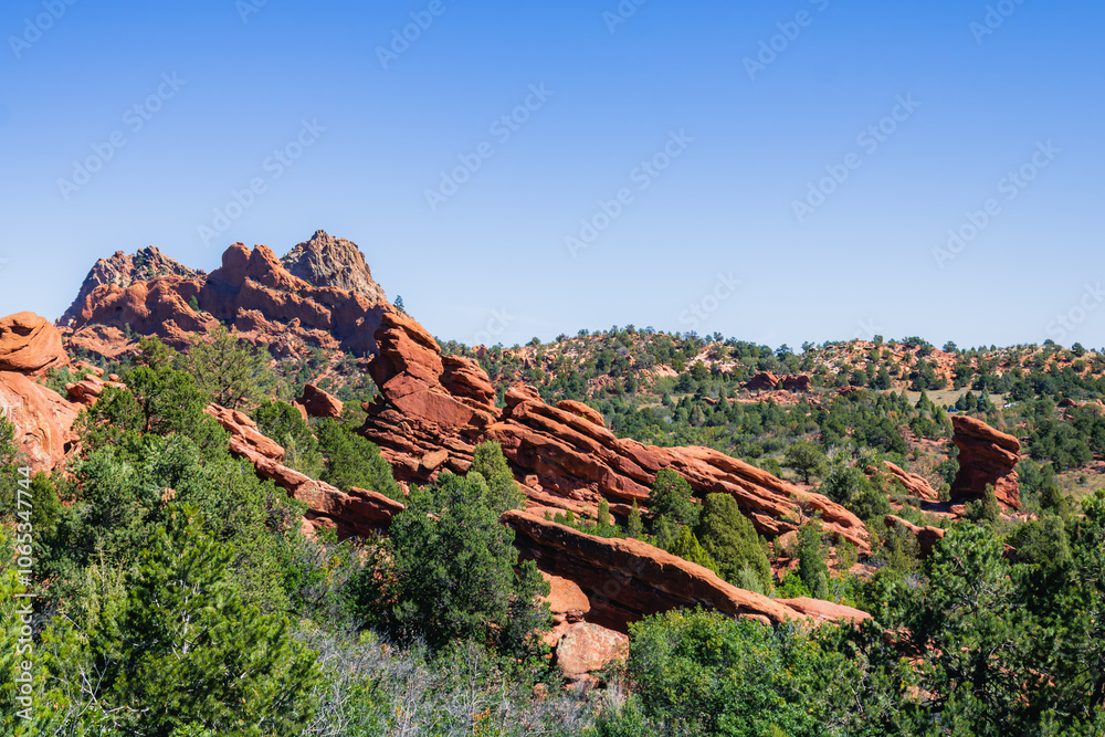 Majestic Red Rock Formations Amidst Lush Greenery