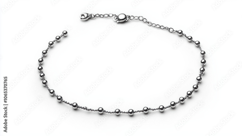 Fototapeta premium Delicate silver anklet with charm, showcasing its elegance