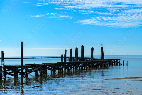 Old broken wooden pier on the beach in Biloxi Beach, Mississippi, USA photo