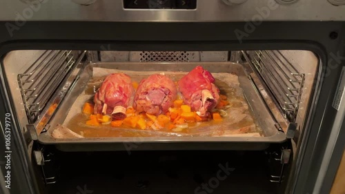 Pork knuckle baked on a baking sheet in the oven. Delicious restaurant or homemade dish for a festive lunch or dinner. Fatty high-calorie male food. Oven-cooked meat