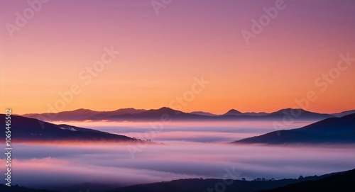 Sunrise over misty mountains warm hues and morning fog