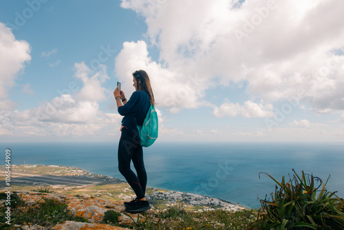 woman on Sunrise Wildflowers on Santorini island, greece photo