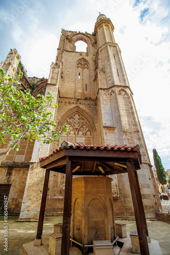 Fountain and facade of st Nicholas cathedral, Lala Mustafa Pasha mosque Famagusta (Magosa) Cyprus  photo