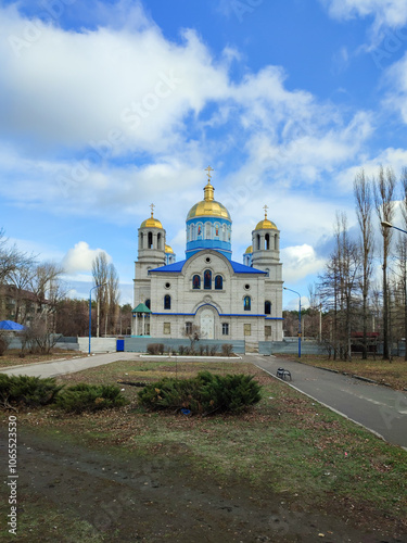 A large blue and white church with a gold dome photo