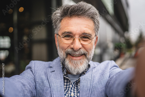 self portrait of senior mature man smile and pose outdoor photo