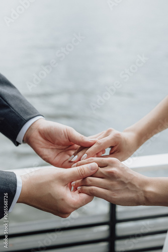 Close-up of the bride and groom holding hands
