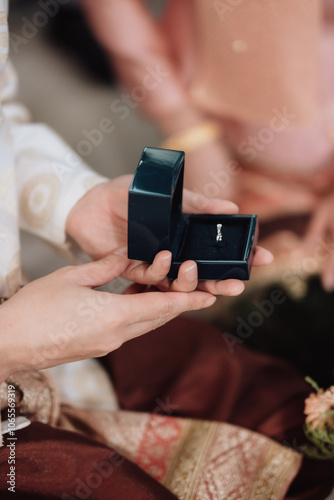 The bride and groom wear wedding rings.