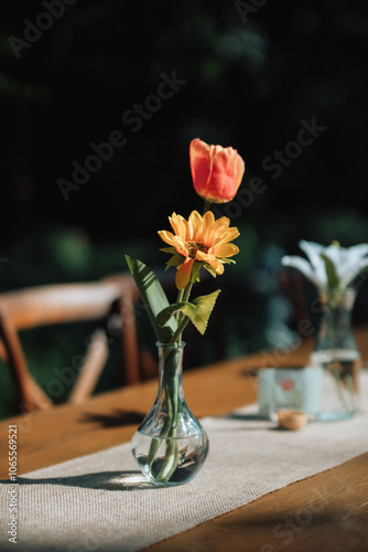 Flowers on a long dining table at a wedding