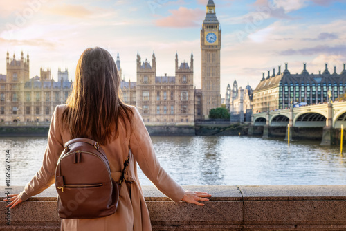 Canvas Print A tourist woman enjoys the sunset view of the Big Ben Tower at Westminster, Lond