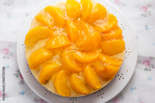 Cake with vanilla cream, peaches and white glaze 