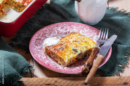 Obraz na płótnie Oven baked omelette with vegetables served with sour cream on wooden background. w salonie