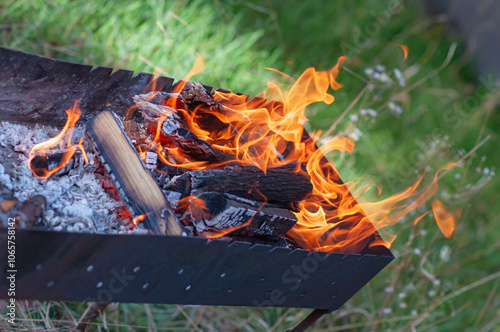 burning wood in a metal grill