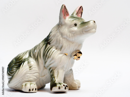 In tis photoillustration Vintage porcelain figurine of dog on white background