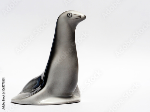 In tis photoillustration Vintage porcelain figurine of fur seal on white background