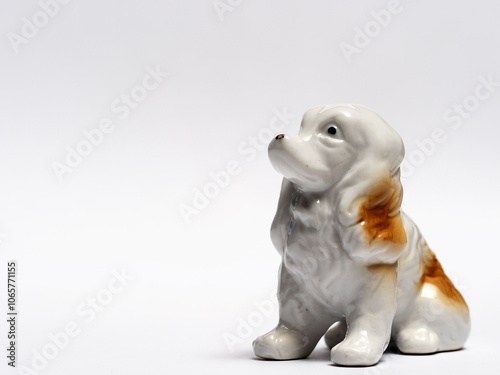 In tis photoillustration Vintage porcelain figurine of dog on white background