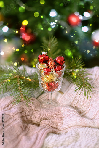 Christmas, New Year holidays background. glass goblet with christmas balls and christmas tree, winter season. still life with festive decor.