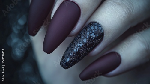 Matte burgundy nail art with textured accent, close-up hand photography for beauty and fashion design photo