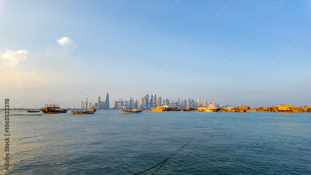 Fototapeta premium Dhow Cruise during sunset time at Dhow harbour background skyscrapers.