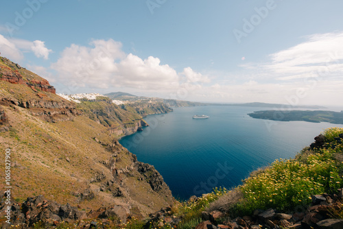 Skaros Rock at Imerovigli village with volcanic island Nea Kameni in background, Santorini, Greece photo