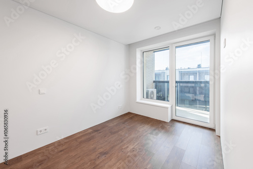 Empty white walls room corner and window. Interior with empty room with white walls and wooden floor.