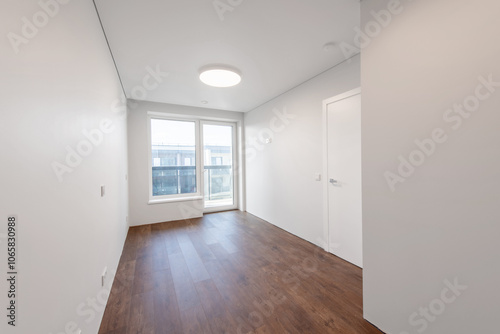 Empty white walls room corner and window. Interior with empty room with white walls and wooden floor.