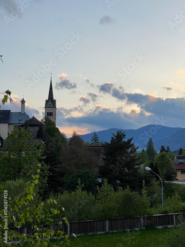 Charming village church and serene landscape at sunset in Austria photo