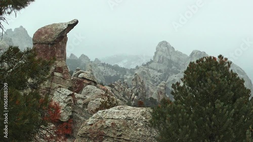 Panning shot past rock formations in a snowstorm in Castle Rocks State Park, Idaho.
