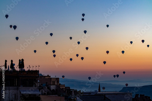 Views of Cappadocia, hot air balloons at dawn against the backdrop of tuff mountains and cave houses photo