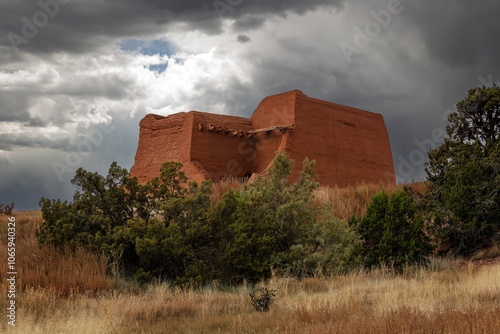 Storm clouds over adobe Pecos Pueblo Mission Church ruins in Pecos Pueblo Historic National Monument New Mexico, USA during autumn.