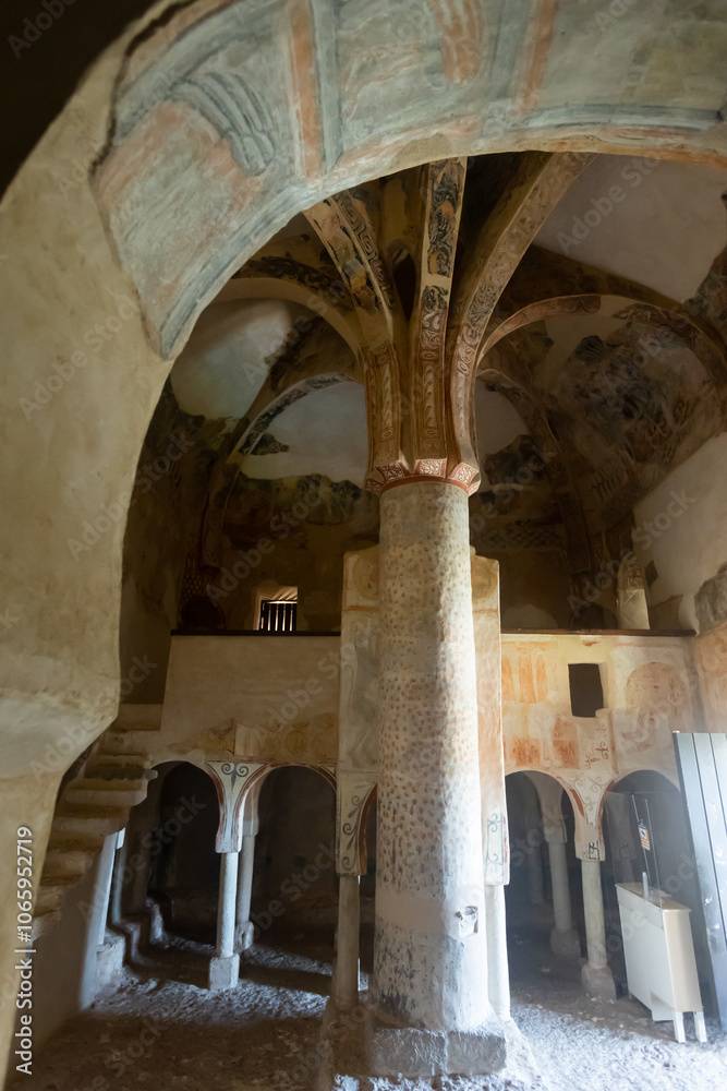 Naklejka premium Remains of antique Romanesque frescoes on walls, ceiling and supporting pillar in ancient Church of San Baudelio de Berlanga in Spanish province of Soria