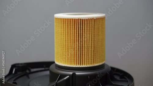 Replacing the air filter on a household vacuum cleaner. Close-up
