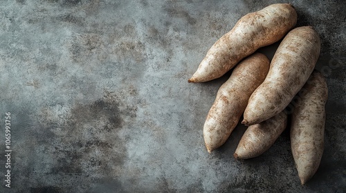 tropical cassava tubers, a key carbohydrate source, beautifully arranged on a textured surface, showcasing their rough skin and starchy interior, reflecting the essence of natural food sources