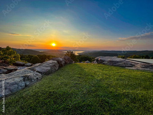 Mountain top view in sunset with rocks and grass field photo