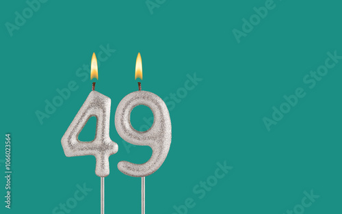 Birthday card on a green background - Candle in the shape of the number 49